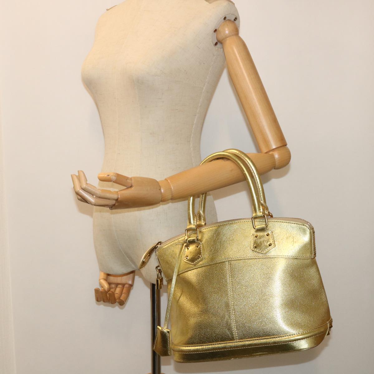 Louis Vuitton Lockit Gold Leather Hand Bag